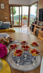 Minimalistic and stylish breakfast with chia yogurt and fresh strawberries served in a bright cozy apartment. Healthy lifestyle and clean eating inspiration.