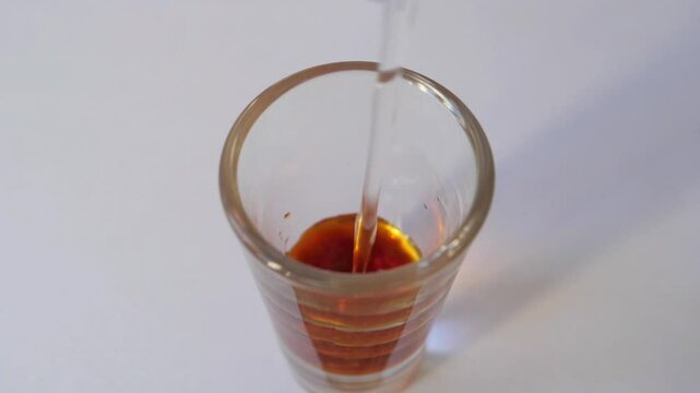 Pouring water into Lugol's solution. Iodine