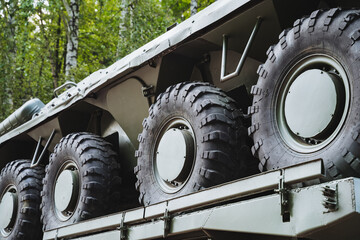 A large collection of tires can be seen positioned on the back of a vehicle, ready for use or...