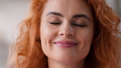 Close up face portrait happy smiling positive dreaming woman closed eyes wish dream carefree smile...