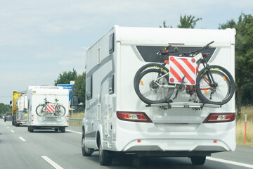 Camper vans driving on a highway.