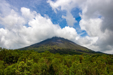 Panoramic view of the Arenal Volcano in Costa Rica, with the Arenal Volcano among clouds as the...