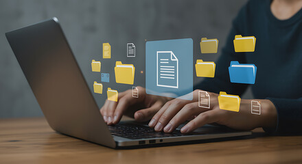 Person working on laptop with virtual folders representing file management and data organization