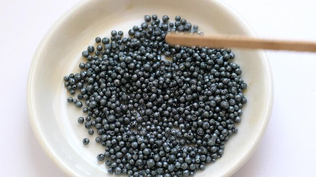 Iodine crystals (granules) at the white dish