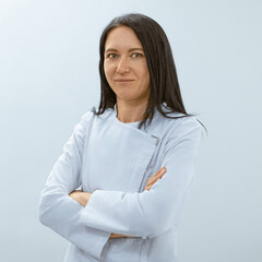 A surprised woman in a medical uniform raising her arms, appearing shocked or amazed.