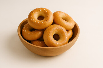 A bowl full of delicious bagels isolated on white background
