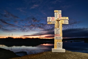 Stone Block Cross With Dawn Sky Reflection