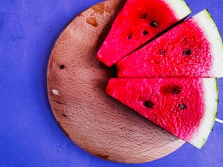 fresh watermelon slices on a wooden board