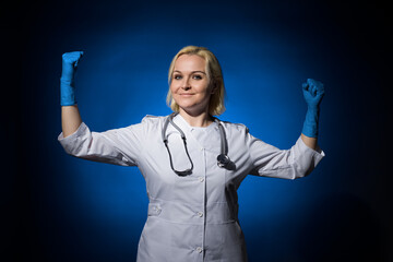 female doctor shows a sign of strength from the dark