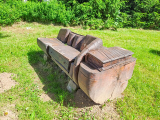 Harrachov- Czech- 26 June 2025: Hand-carved wooden bench in the city park