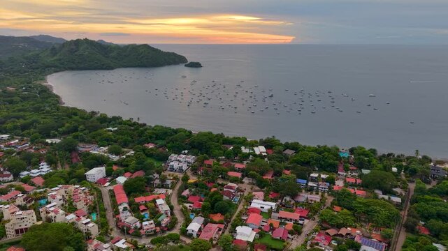 Aerial footage of Playas del Coco, Costa Rica &mdash; golden beaches, lush hills, and a scenic bay filled with yachts, perfect for tourism, ocean adventures, and tropical getaways