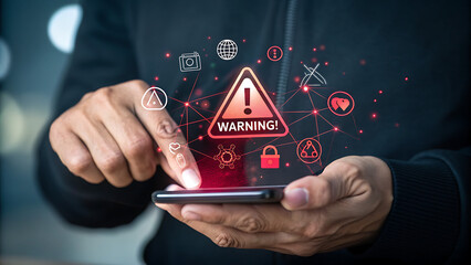 Photo of a persons finger points to a warning symbol on a smartphone screen, surrounded by digital icons representing various online threats and security concerns