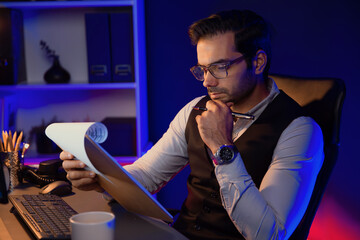 Serious smart businessman focusing on paperwork report folder analyzing sales channel discipline's...