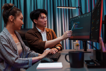 IT developers discussing with point to intelligent website development coder system running data...