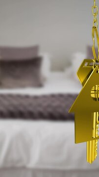 Animation of gold house key fob and key hanging in front of blurred house with sold sign