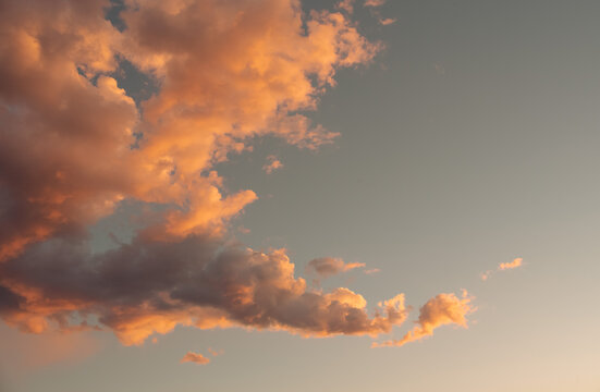 Evening dusk clouds during sunset, idyllic nature clouds, dramatic sunlight with majestic peaceful sky in summer season