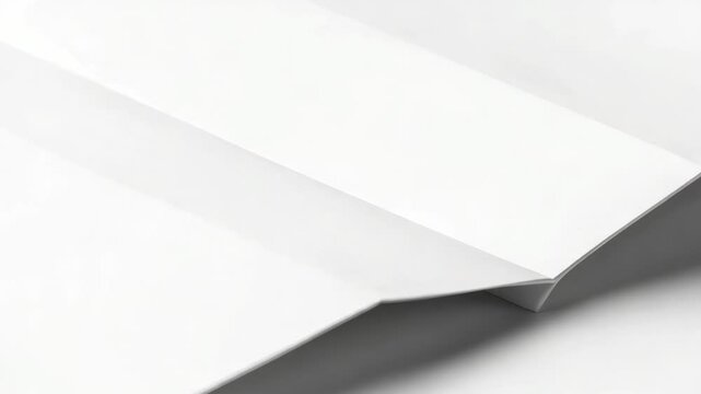 A close-up shot of a folded white paper on a table, suitable for use in presentations, reports or office settings