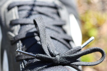 A detailed view of a shoelace knot on a shoe, useful for illustrating footwear or fashion details