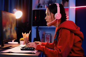 Host channel of young beautiful Asian gaming streamer playing fighting Moba at battle arena game on...