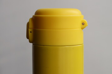 A yellow cup on a table, perfect for everyday use or as a prop in photography and filmmaking