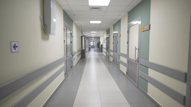 Empty brightly lit hospital corridor with closed offices doors. Minimalist interior design of luxury private clinic. Healthcare facility