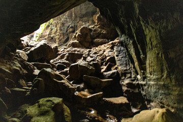 Alutila Cave entrance surrounded by forest.