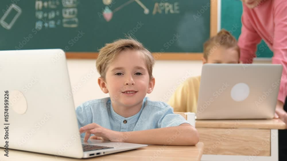 Poster caucasian boy working at laptop while diverse children programing software system. teacher and stude