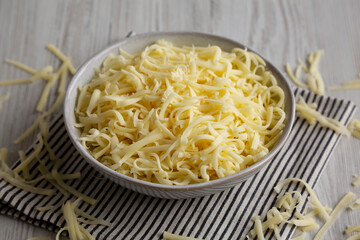 Organic Shredded Mozzarella Cheese in a Bowl, side view.