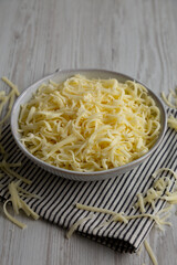 Organic Shredded Mozzarella Cheese in a Bowl, side view.