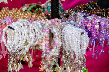 Various types and models of beaded bracelets are arranged on display.
