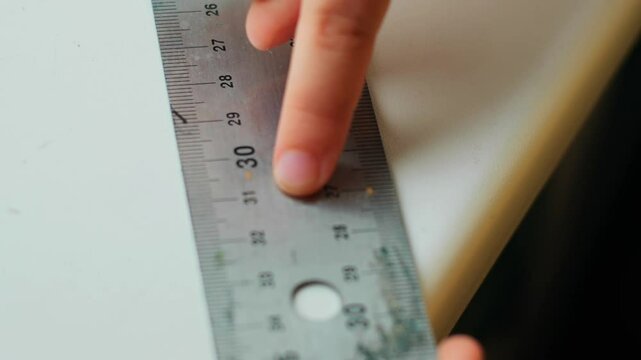 Measuring and Marking - Hand Using Metal Ruler to Measure and Mark for Accurate Craftsmanship - centimeters and inches  