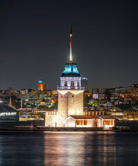 Fototapeta premium A night view of the famous Maiden's Tower, also known as Leander's Tower, a symbol of Istanbul, over the Bosphorus. Scenic travel background for wallpaper or guidebook. Istab