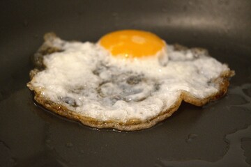 One fried egg in the pan close up