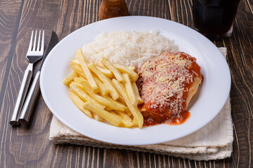 Parmegiana chicken breast, rice and french fries. Typical brazilian executive dish