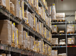 Modern warehouse shelves with stacked pallets and cardboard boxes