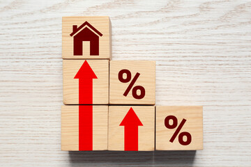 Increase in real estate value. Cubes with house icon, arrows and percent signs on white table, top...