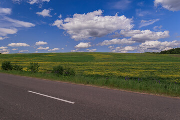 Fototapeta premium Highway wide road, transport and blue sky with clouds on a summer day