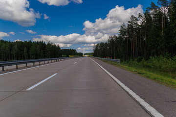 Highway wide road, transport and blue sky with clouds on a summer day