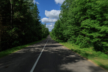 Road view on a summer day. Highways, roadside and white road line markings.