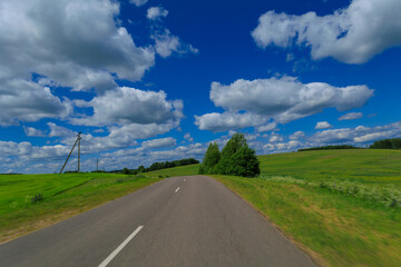 Road view on a summer day. Highways, roadside and white road line markings.