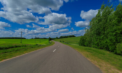 Fototapeta premium Road view on a summer day. Highways, roadside and white road line markings.