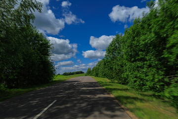 Road view on a summer day. Highways, roadside and white road line markings.