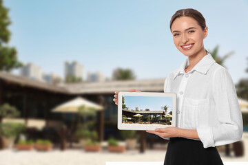Young hostess with tablet computer presenting sea resort