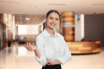 Young hostess in uniform at hotel lobby