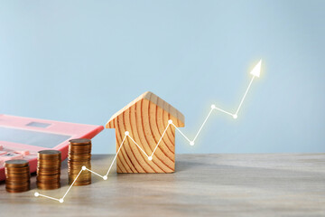 Increase in real estate value. House model, coins and calculator on table. Growing price...