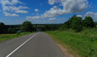 Road view on a summer day. Highways, roadside and white road line markings.