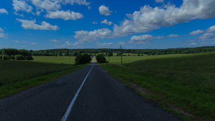 Road view on a summer day. Highways, roadside and white road line markings.