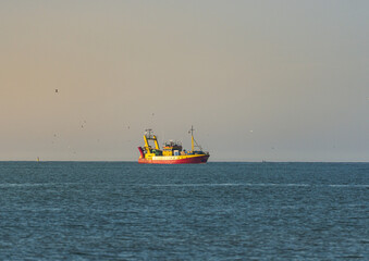 Fisherman's transport ship at sea. Ship at sea in the evening sunlight.