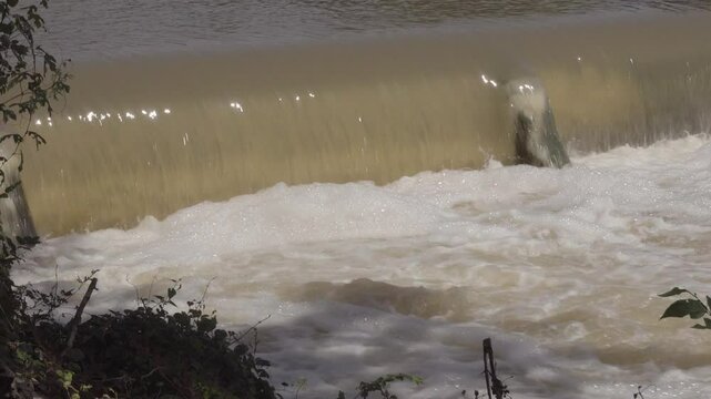 Texas 2025 flood water being released and running over small dam