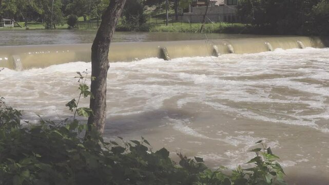 Texas 2025 flood water being released from flood control dam upstream and running over smaller dam